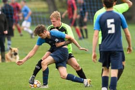 A Mother Shipton player gets tight to his man in his side's crushing 10-1 London Cup crushing of City of Portsmouth Sunday League rivals AFC Solent (blue) last weekend. Picture: Keith Woodland (101021-204)