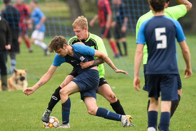 A Mother Shipton player gets tight to his man in his side's crushing 10-1 London Cup crushing of City of Portsmouth Sunday League rivals AFC Solent (blue) last weekend. Picture: Keith Woodland (101021-204)