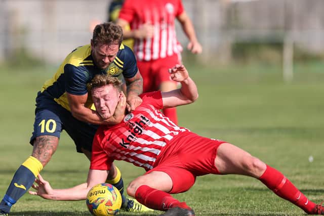 Moneyfields striker Steve Hutchings, left, battles for possession during the FA Cup win against Camberley. Picture: Chris Moorhouse