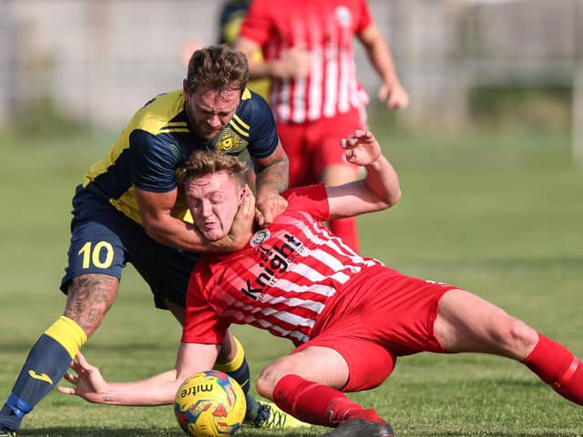 Moneyfields striker Steve Hutchings, left, battles for possession during the FA Cup win against Camberley. Picture: Chris Moorhouse