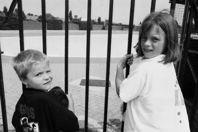 Locked out! Ricky Worsfold and Laura Barley behind the bars of the lido plash pool which was closed because of a pump breakdown in July 1995.