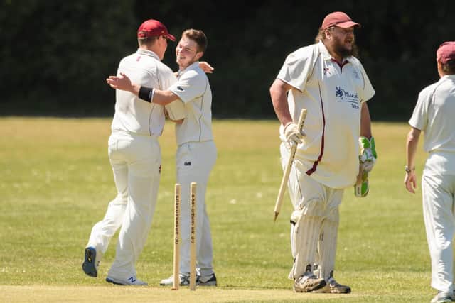 Portchester's Darren Stares, second left, is congratulated after taking two quick wickets.
Picture: Keith Woodland