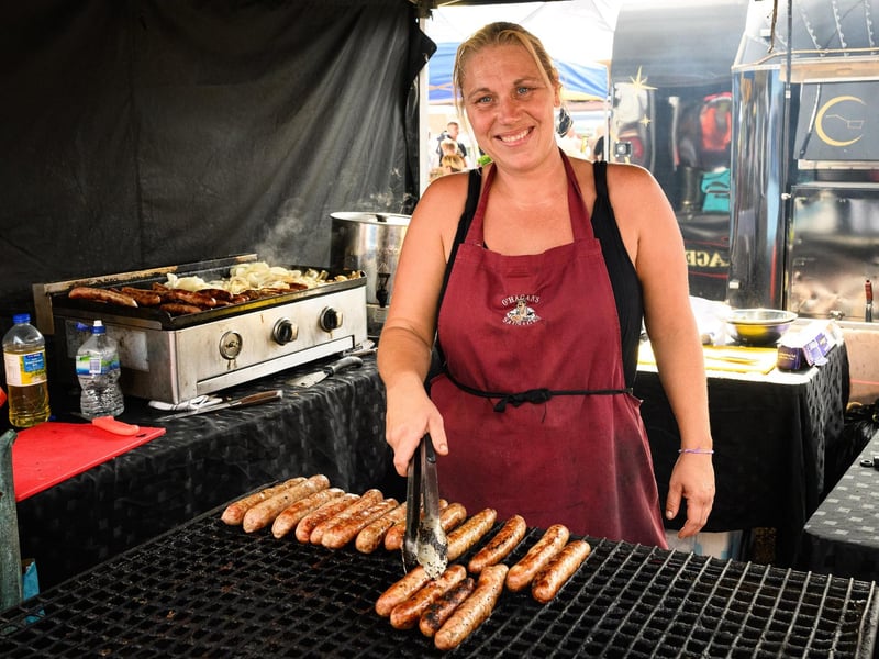 Pictured is: Hayley cooks some more sausages at O'Hagan's sausage stall.
Picture: Keith Woodland (100921-18)