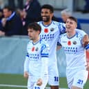James Roberts celebrates his first goal with Oscar Gobern and Benny Read. Picture by Dave Haines.