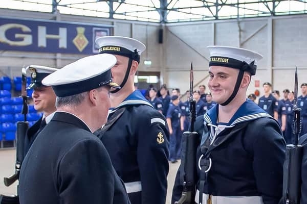 Commodore Don Mackinnon talking to his son Tom on parade at HMS Raleigh.