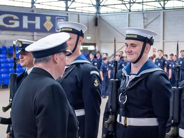 Commodore Don Mackinnon talking to his son Tom on parade at HMS Raleigh.