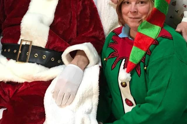 Santa at Coco's with Jackie Avis (standing) and elf Belle.