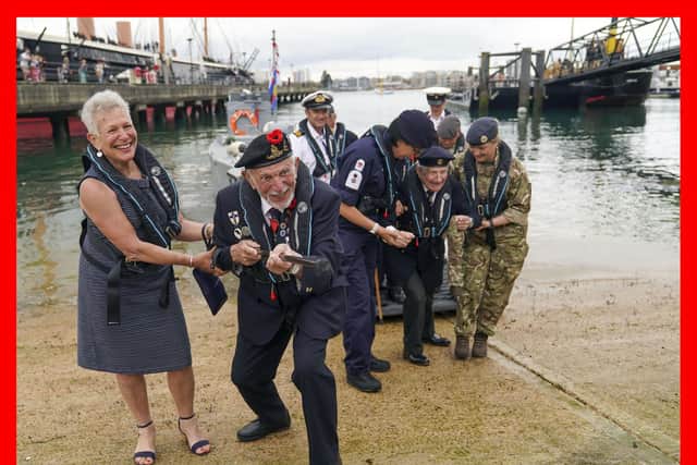 D-Day veteran Joe Cattini raises his walking stick like a machine gun as he and other veterans are welcomed to the Portsmouth Historic Dockyard to commemorate the 77th anniversary of the Normandy Landings. Picture: Steve Parsons/PA Wire