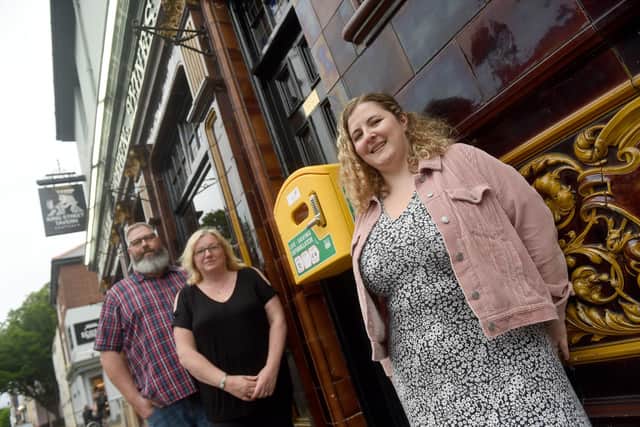 A defibrillator was unveiled at The King Street Tavern in King Street, Southsea, on Thursday, June 9, after Morris dancer Jim Seal from Victory Morrismen had a cardiac arrest at the pub on September 2, 2021.Pcitured is: (l-r) Landlord of The King Street Tavern Sean Marshall, his wife and captain of the pubs darts A team Mandy Marshall and Bethan Grundy, member of the darts A team and who gave CPR to Jim Seal.Picture: Sarah Standing (090622-9800)