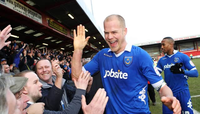 An iconic Pompey photo - with skipper Johnny Ertl celebrating with supporters following the March 2013 triumph at Crewe. Picture: Joe Pepler