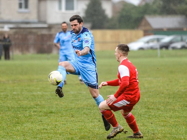 Scott Jones scores for AFC Portchester (blue) v Bournemouth Poppies. Picture by Daniel Haswell