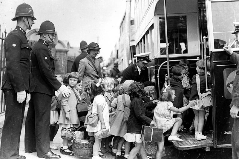 Portsmouth children being evacuated in 1939. The girl on the left is Marjorie Charman nee Watts. Evacuees board buses at George Street, Portsmouth at the beginning of the Second World War. The News PP5415