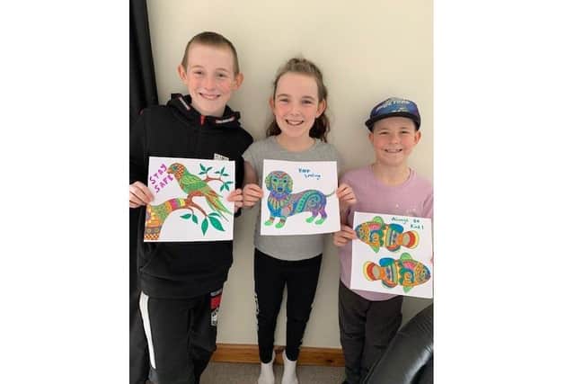 Finlie, Ebonie and Tobbie Hynd from Fareham have been creating colourful pictures to give to their neighbours and brighten their days
