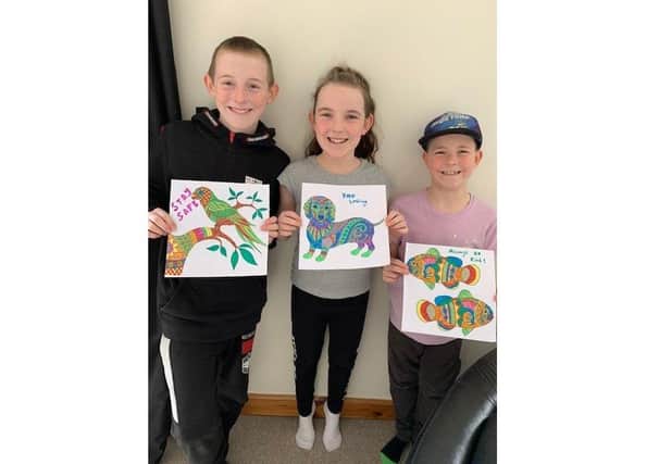 Finlie, Ebonie and Tobbie Hynd from Fareham have been creating colourful pictures to give to their neighbours and brighten their days
