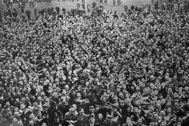 Pompey fans invade the Fratton Park pitch after the final whistle.