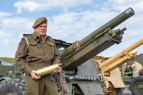 Cliff Mandville (58) with a cartridge used by the 25 pounder guns in the firepower demonstration. Picture: Mike Cooter