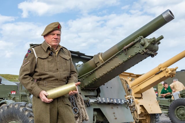 Cliff Mandville (58) with a cartridge used by the 25 pounder guns in the firepower demonstration. Picture: Mike Cooter