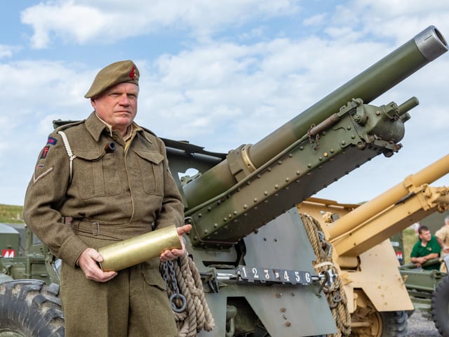 Cliff Mandville (58) with a cartridge used by the 25 pounder guns in the firepower demonstration. Picture: Mike Cooter