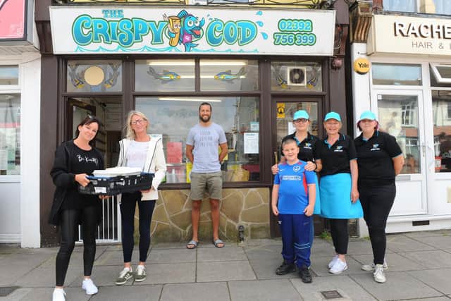 From left, volunteers Jeanette Warren, Emma Faith, Portsmouth FC player Christian Burgess with the team at The Crispy Cod; Laura Bucknall with her son Reggie Bucknall-Lees (7), mum Tracey Bucknall and sister Hayley Bucknall. Picture: Sarah Standing (190620-127)