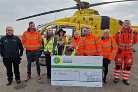 LAUNCH: The team from Barnbrook Systems and Flair, including managing director Andrew Barnett (third right) and finance director Anna Barnett (fourth right), present Hampshire and Isle of Wight Air Ambulance with £2,000 to mark the start of their support for the charity