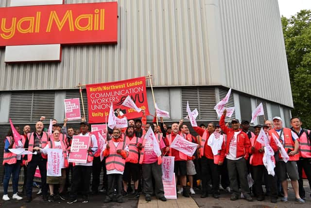 Royal Mail postal workers hold placards and chant slogans as they stand on a picket line outside a delivery office, in north London, on September 8, 2022 during a strike. Picture: JUSTIN TALLIS/AFP via Getty Images.