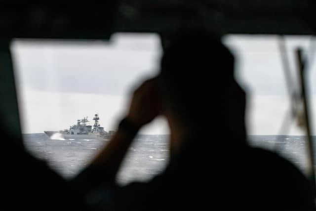 A sailor on board HMS Northumberland monitors the movement of Vice-Admiral Kulakov