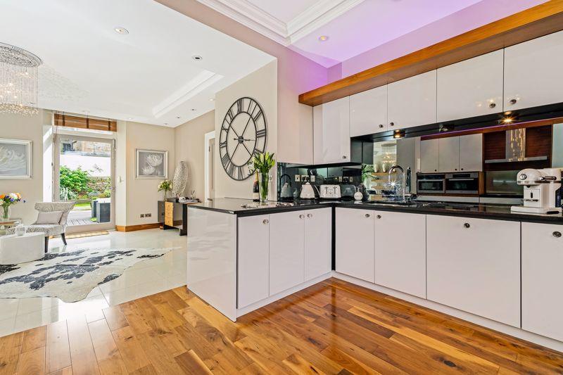 The stylish and modern kitchen has integrated Miele appliances which include; hob, oven, oven microwave, cooker hood, dishwasher and an "American" style fridge/freezer, as well as granite worktops and a polished walnut floor.
