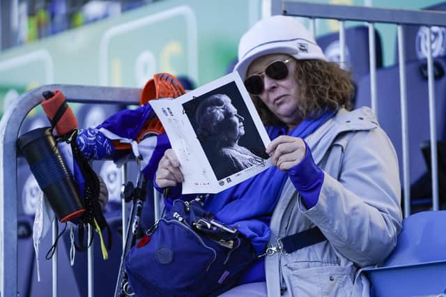 A Pompey fan reads today's programme before the top-of-the-table clash with Plymouth. Picture: Jason Brown/ProSportsImages