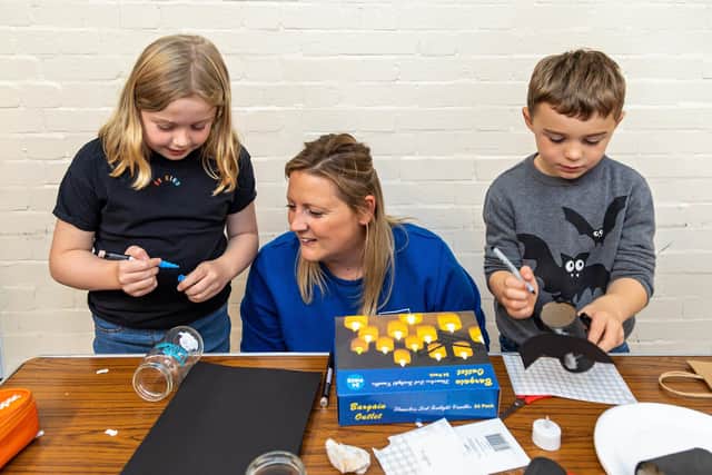 Georgina Smith (centre) overseeing craft activities with Tilly Moss (8) and Sam Daltrey (7). Picture: Mike Cooter (281021)