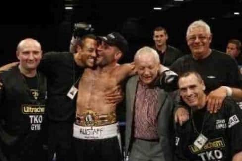 Trainer Michael Ballingall, second left, congratulates Tony Oakey, third left, after his British light heavyweight title win