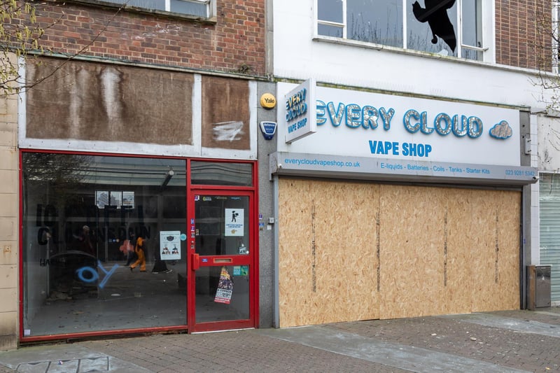 Boarded up shops and spray-painted windows on Arundel Street