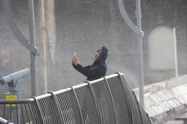 Man takes selfie during Storm Eunice in Old Portsmouth. Picture: Alex Shute
