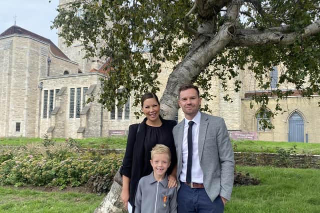 The Queen's funeral is being screened at St Mary's church on Monday 19th September 2022 Pictured: Nicole and Nathan Geddis with son Jack Geddis outside Portsmouth Cathedral.