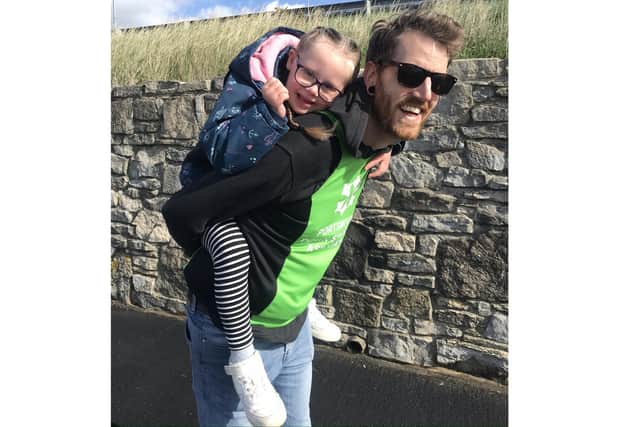 Ben Brooks is taking on a mile each day for 21 days using various methods of unusual transport to raise funds for Portsmouth Down Syndrome Association's T21 Challenge. Pictured: Ben with his daughter Robin, six, during the mile where he carried her