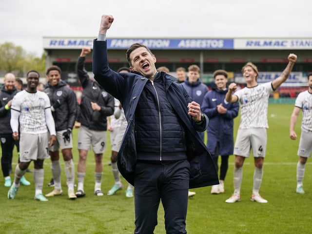 John Mousinho celebrates in front of the travelling Fratton faithful at the final whistle