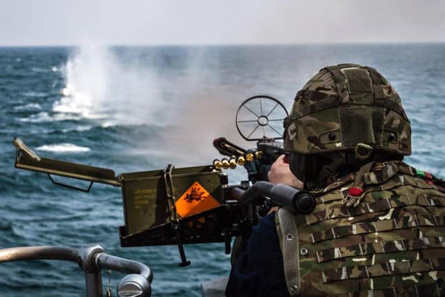 Crew of HMS Chiddingfold firing a M134 Minigun during live fire training.