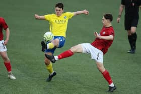 Hawks' Joe Warren, left, wins the ball from Camberley's Charlie Ludlow. Picture by Dave Haines.