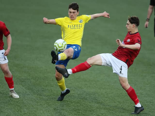 Hawks' Joe Warren, left, wins the ball from Camberley's Charlie Ludlow. Picture by Dave Haines.