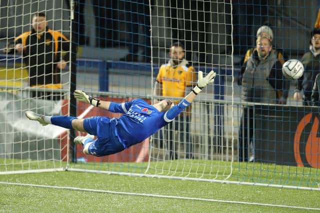 Hawks keeper Will Mannion dives full length. Picture: Dave Haines
