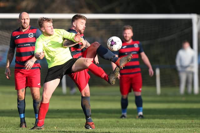 Paulsgrove (red/blue) have still got 20 Hampshire Premier League games left to play - more than any other Senior Division side. Picture: Chris Moorhouse