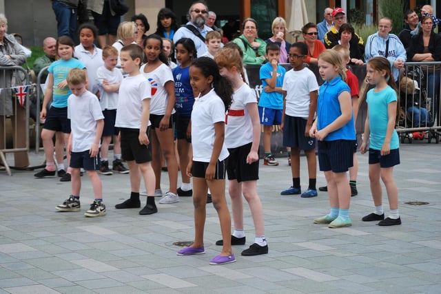 Children from Emmaus Primary School, Wybourn, Sheffield, perform in Tudor Square as part of community celebrations as the Olympic Torch arrives in the city. 25/6/12