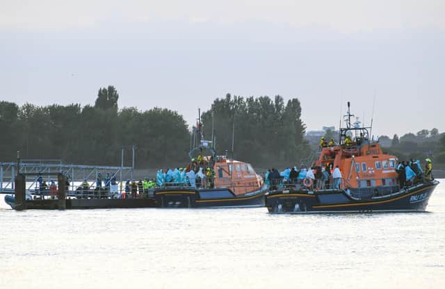 Around 120 migrants arrive in Portsmouth after being transferred from a single dingy south of the Isle of Wight in the English Channel by two RNLI lifeboats