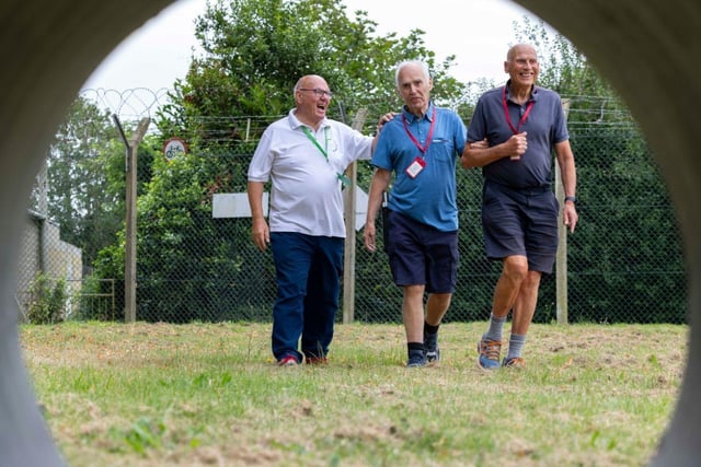 Veterans complete a Sports Day walk at the HMS Sultan Blind Veterans UK Summer Camp.