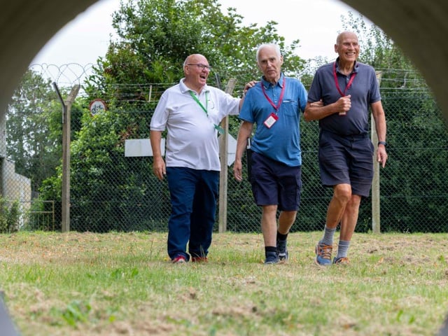 Veterans complete a Sports Day walk at the HMS Sultan Blind Veterans UK Summer Camp.