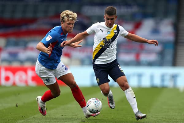Cameron Brannagan and Pompey's Cameron McGeehan. Pic: Andrew Matthews/PA Wire.