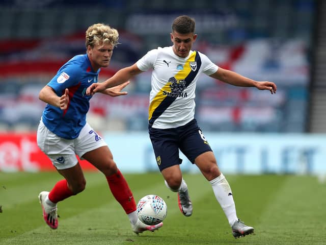 Cameron Brannagan and Pompey's Cameron McGeehan. Pic: Andrew Matthews/PA Wire.
