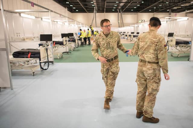Military personnel at the ExCel centre in London which is being made into a temporary hospital - the NHS Nightingale hospital, comprising of two wards, each of 2,000 people, to help tackle coronavirus. Photo: Stefan Rousseau/PA Wire