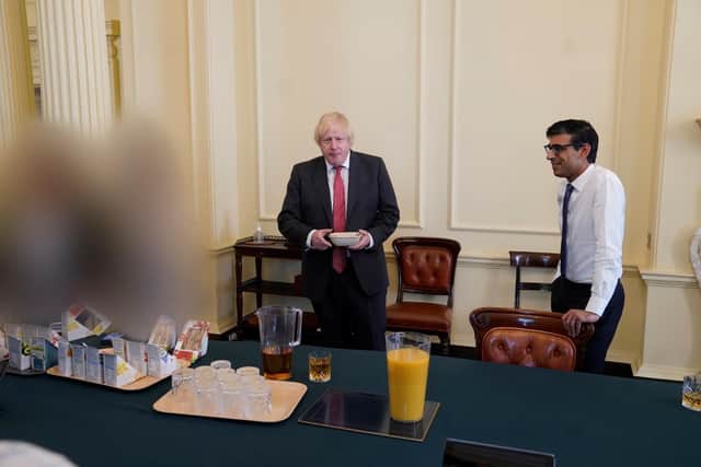 PM Boris Johnson (left) and chancellor Rishi Sunak at a gathering in the Cabinet Room in 10 Downing Street on his birthday, which has been released with the publication of Sue's Gray report into Downing Street parties in Whitehall during the coronavirus lockdown. Issue date: Wednesday May 25, 2022.