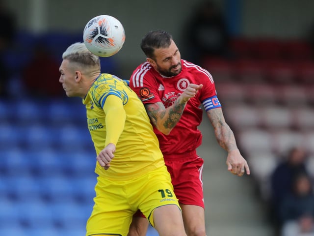 Danny Wright tries to win a header. Picture by Dave Haines