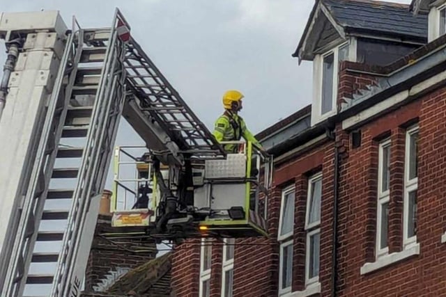 Firefighters fixing loose roof tiles and a sign above Poppins Cafe in North Street, Havant, on January 2.